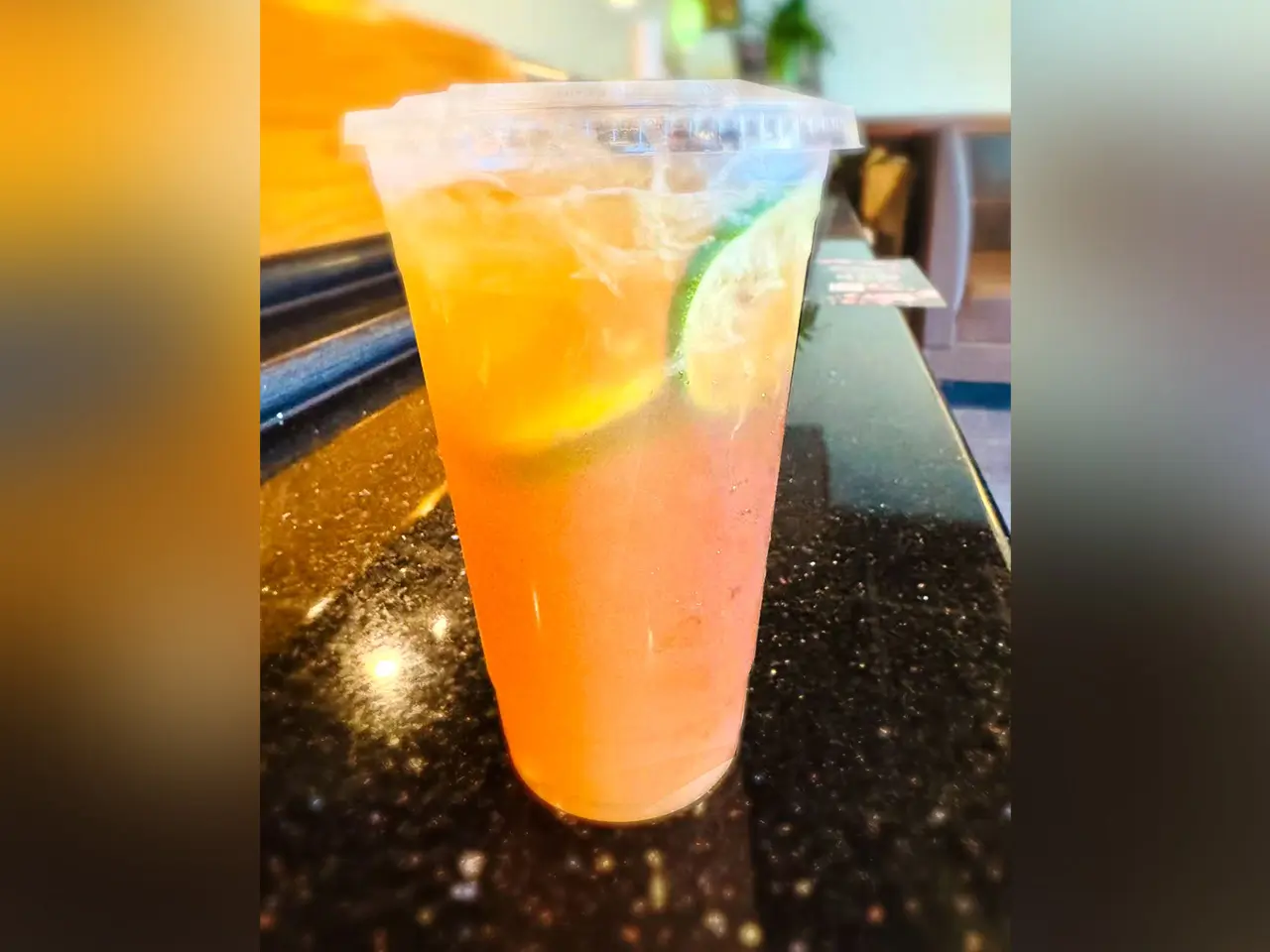Citrus Sparkling Drink Refreshing orange drink with lime slices and bubbles